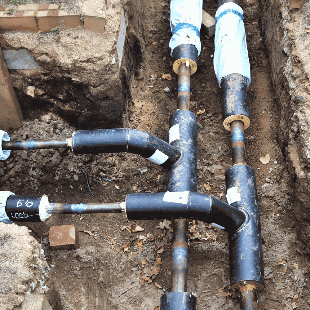 Insulated underground pipework installed in trench at new build
